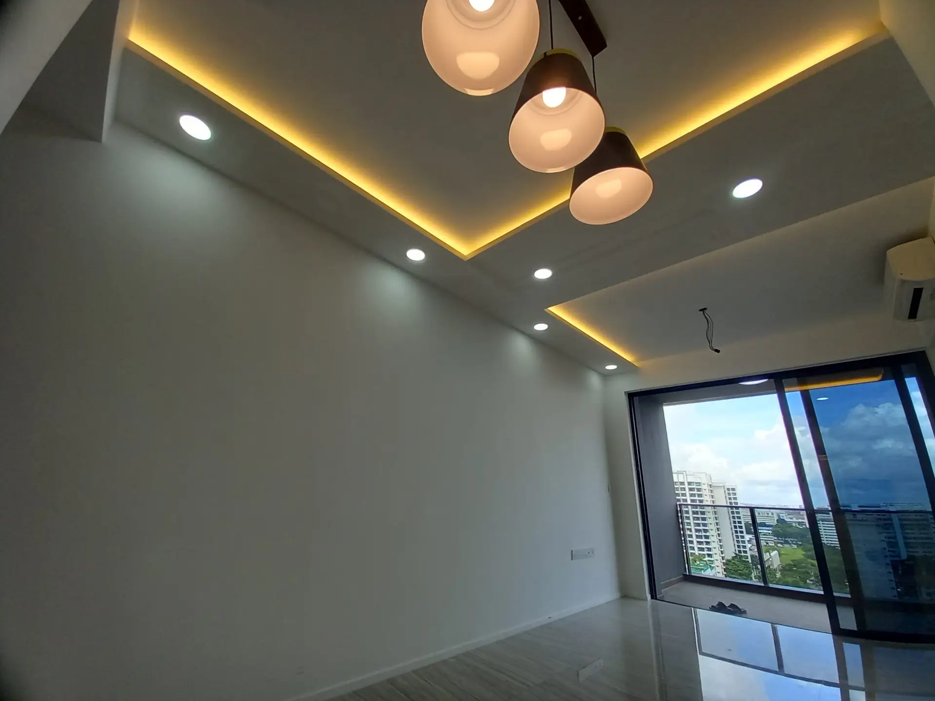 A modern living room at Parc Esta condo featuring a T-shaped covelight false ceiling with recessed lighting, used to visually demarcate the space
