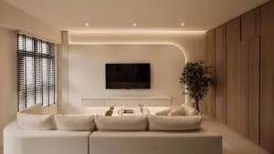 A sleek TV feature wall with a rounded corner, seamlessly integrating into the room's design while concealing media cables