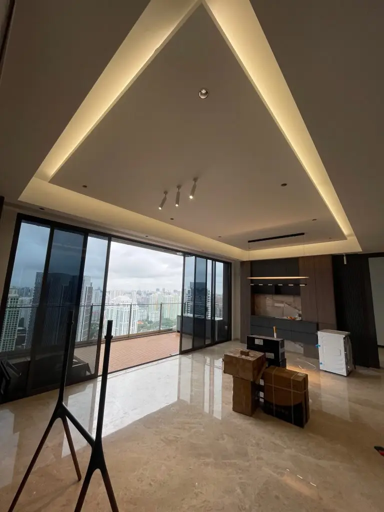 Interior design at **The Avenir**, Singapore: a rectangular island false ceiling with cove lighting serves as a striking focal point and adds a sense of spaciousness to the living room.