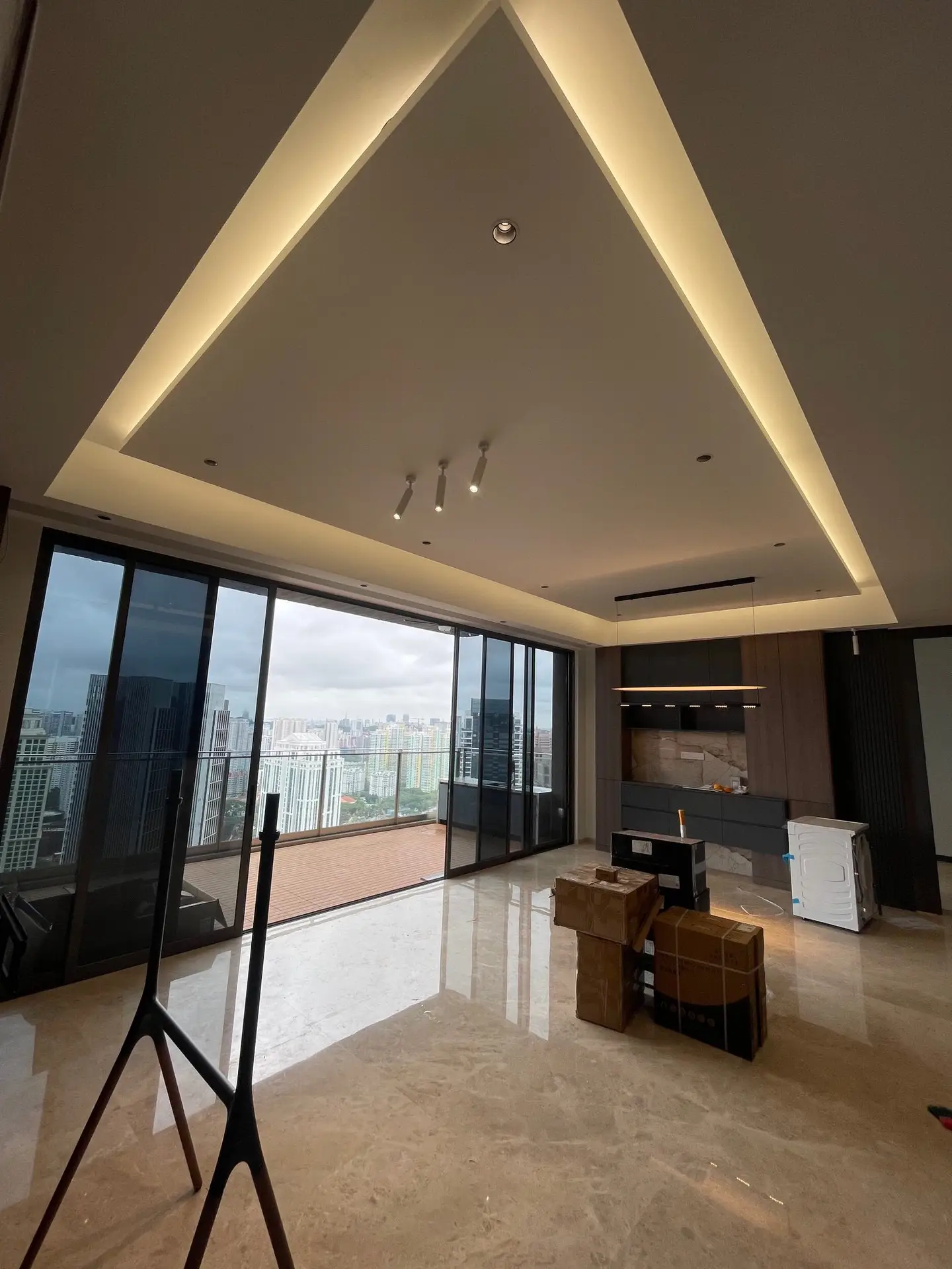 Home 2 Interior design at **The Avenir**, Singapore: a rectangular island false ceiling with cove lighting serves as a striking focal point and adds a sense of spaciousness to the living room.