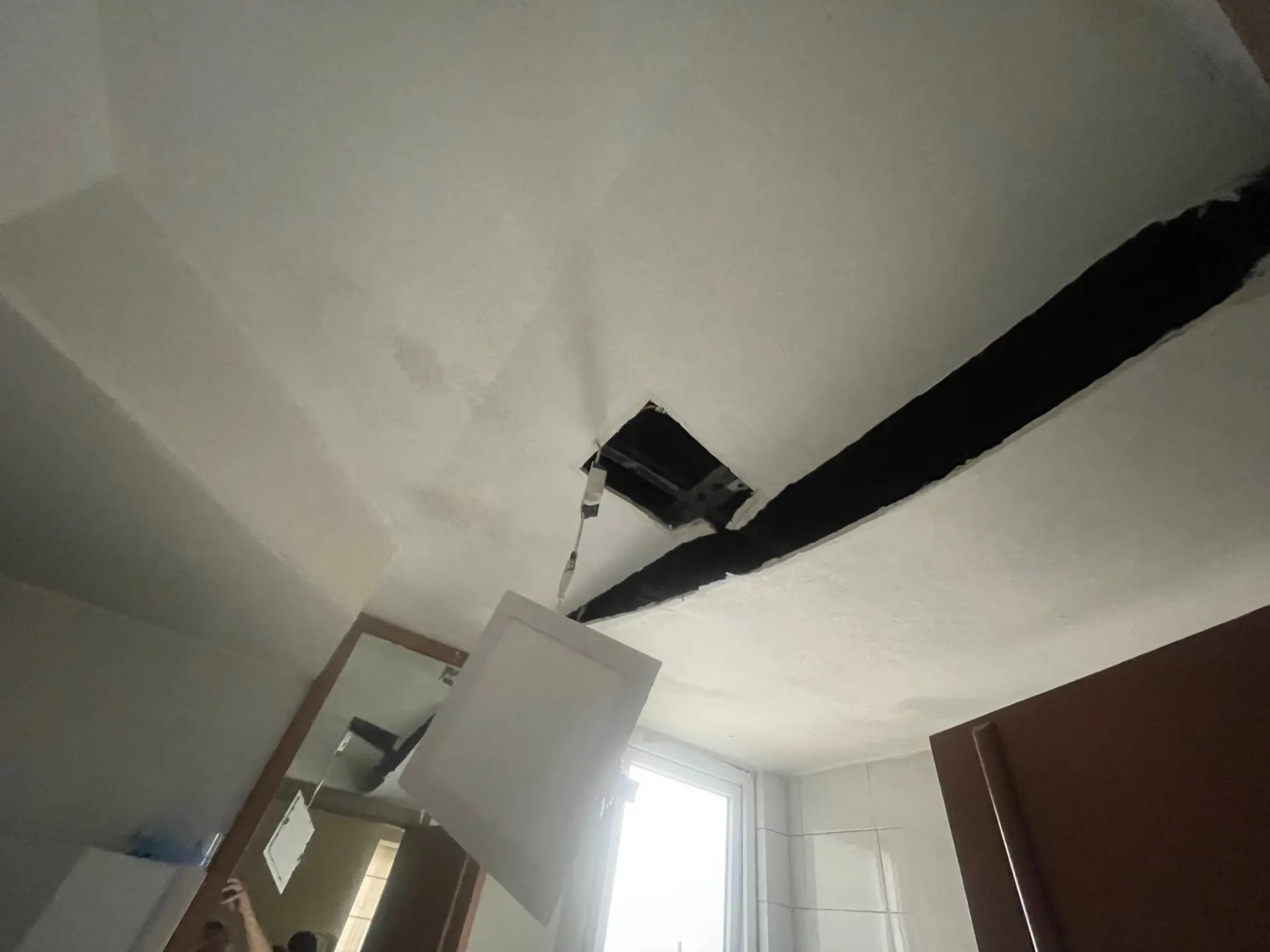 a false ceiling sagging in the bathroom in a Singapore condo